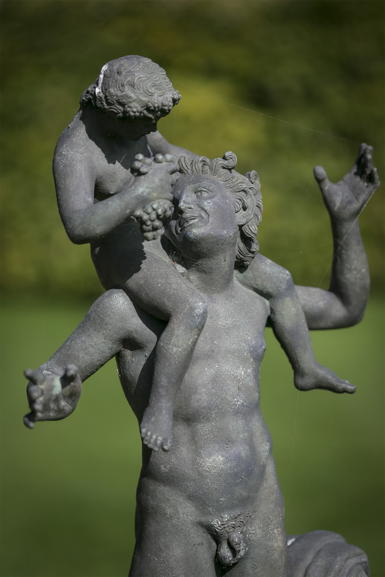 A Neapolitan verdigris bronze model of a young Satyr with the infant